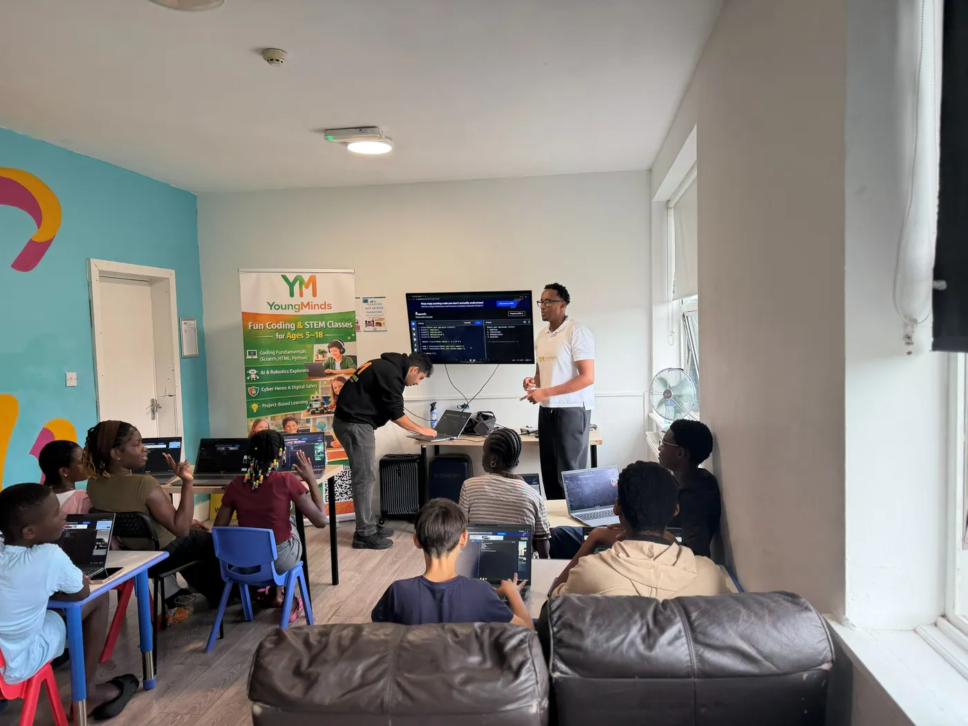 A mentor leading a Python lesson at a community coding session
