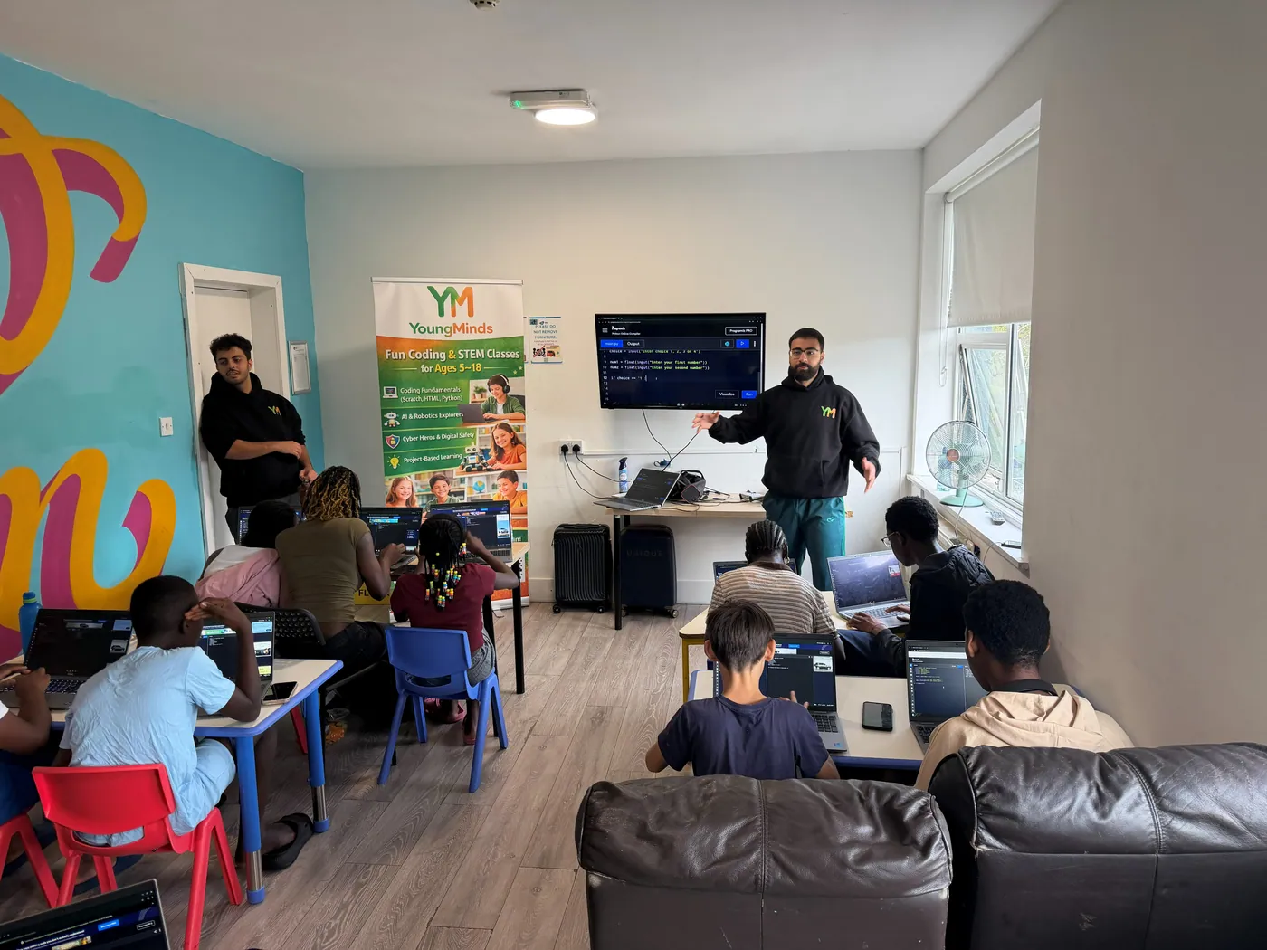 YoungMinds mentors running a coding workshop for young people at a community centre