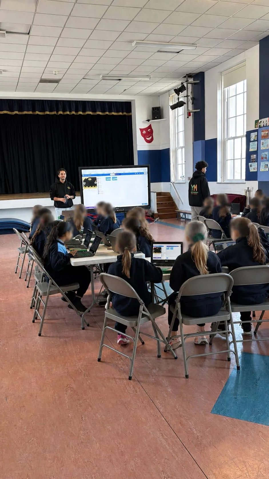 YoungMinds mentor leading a full-day coding session in a school classroom